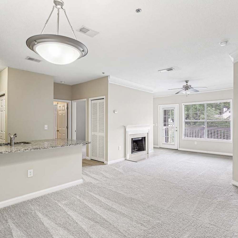Unfurnished living room with fireplace at Grande Oaks in Roswell, Georgia 