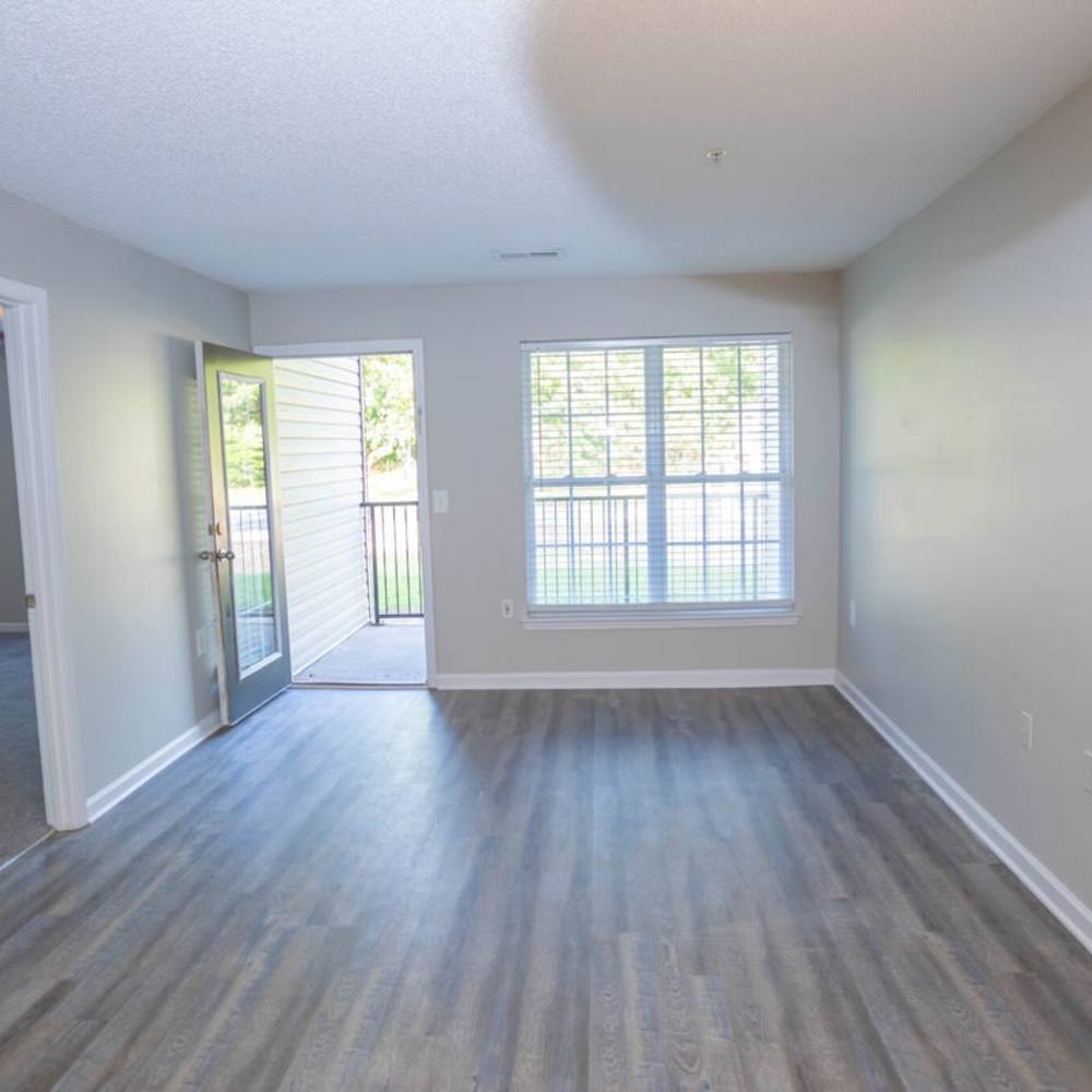 Hardwood-style flooring and balcony access from the living room at Crestmont in Columbia, South Carolina
