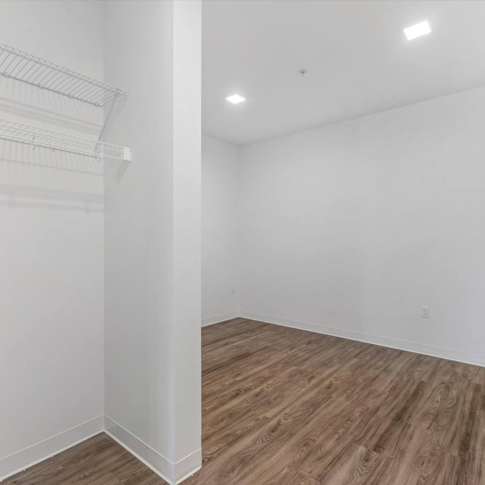 Model bedroom with wood-style flooring at Koz on 13th in Portland, Oregon