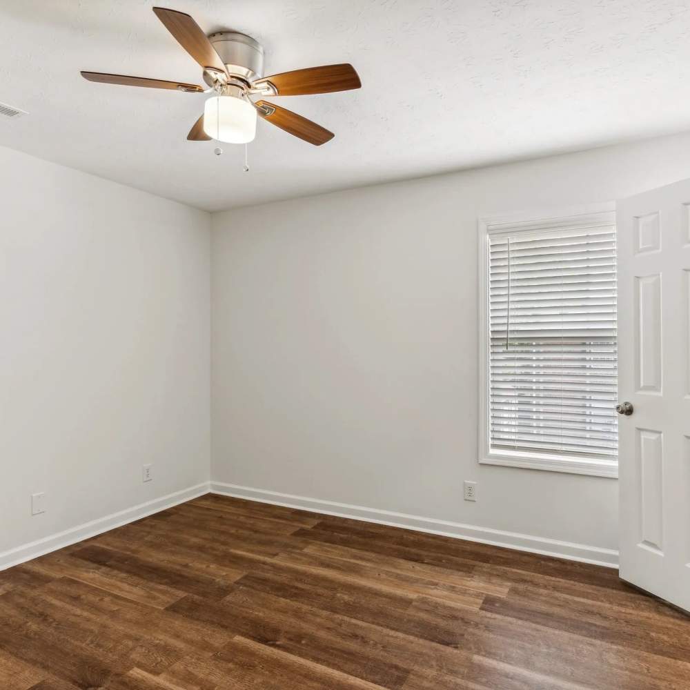 Bedroom with wood-style flooring and a ceiling fan at The Bellevue At 1045 in Cookeville, Tennessee