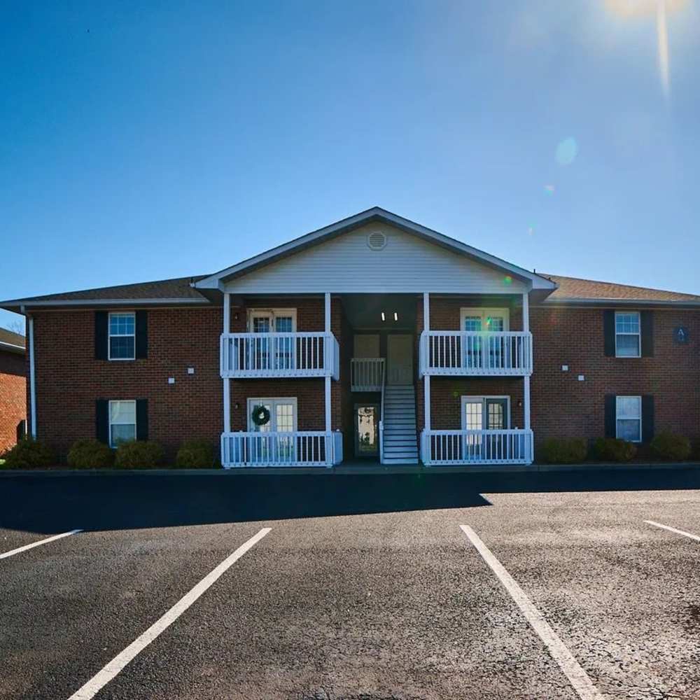View of an apartment building from the parking lot at The Bellevue At 1045 in Cookeville, Tennessee
