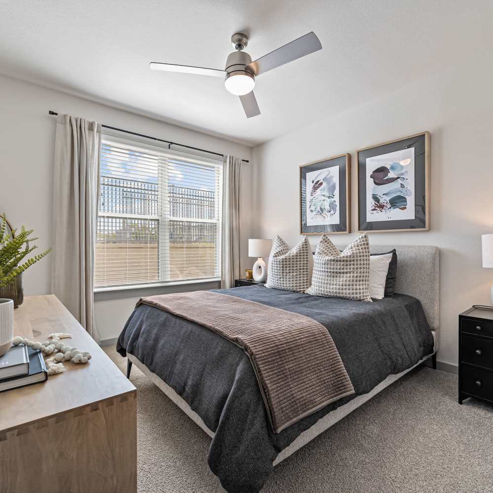 Apartment bedroom with cozy bed at Main and Mill in Lewisville,Texas