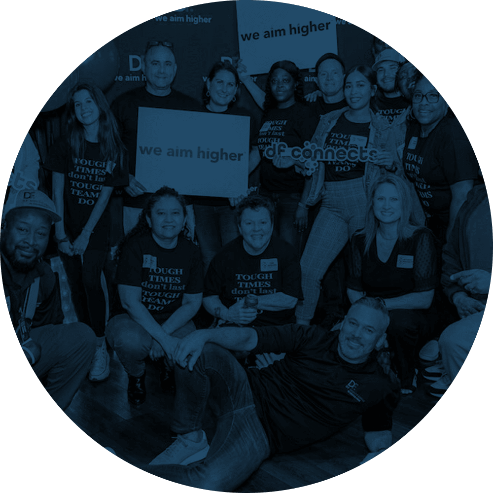 Group of employees gathered for a photo at an event at Drucker + Falk in Newport News, Virginia