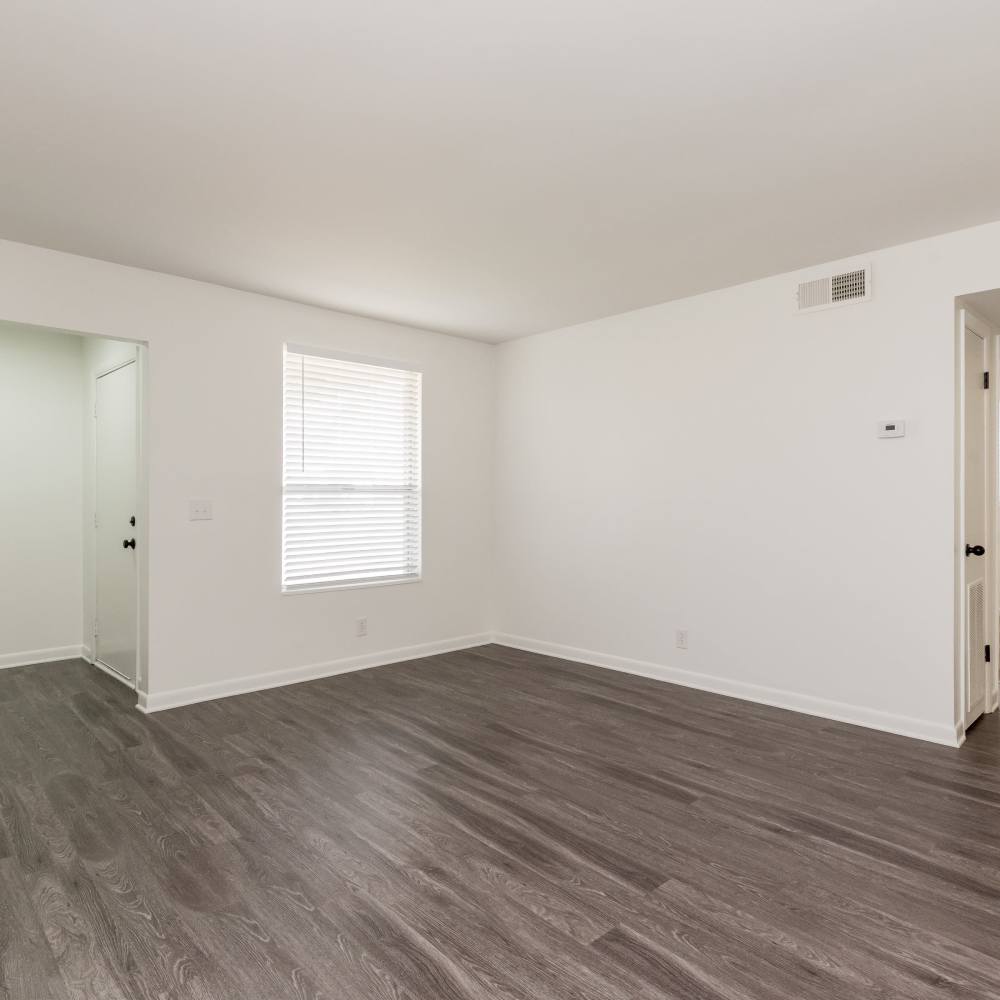 Spacious living area with wood-style flooring at New Village At Hermitage in Hermitage, Tennessee