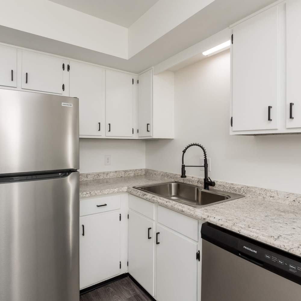 Kitchen with white cabinets and stainless-steel appliances at New Village At Hermitage in Hermitage, Tennessee