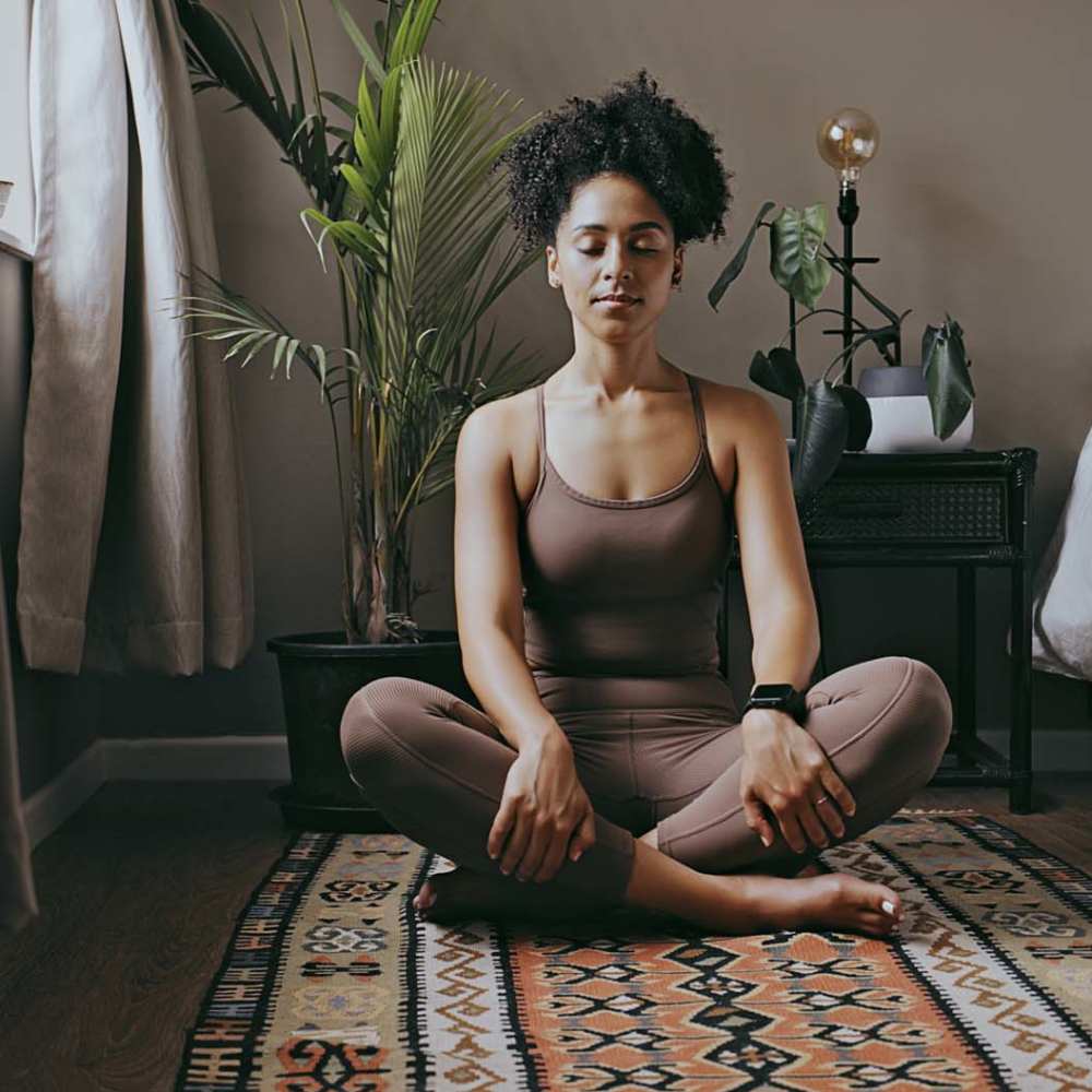 A woman practicing yoga in her apartment home at Marlowe Place in Charlotte,North Carolina