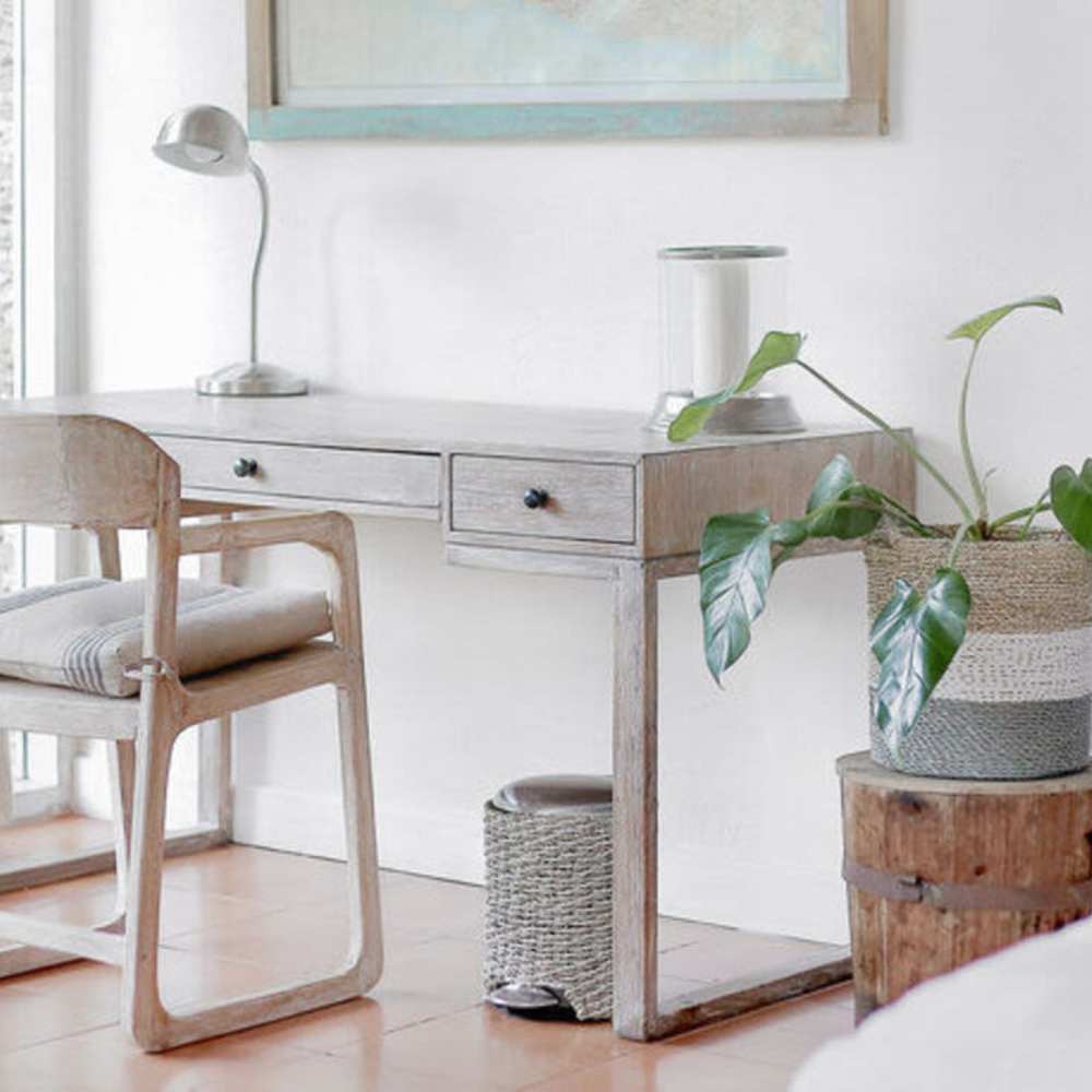 A spacious white bedroom showcasing a desk and chair at Broadway Street Apartments in Lowell, Massachusetts