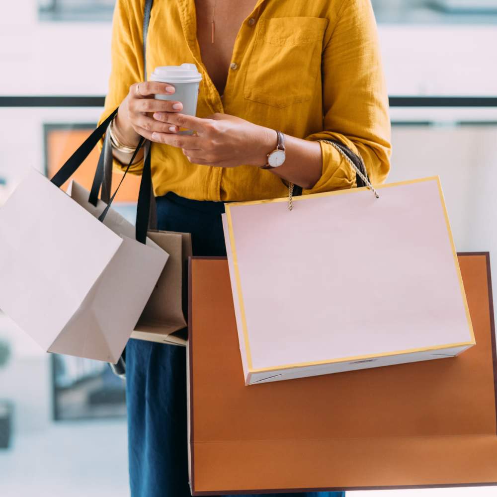 Woman carrying shopping bags near The Edge in Pensacola, Florida