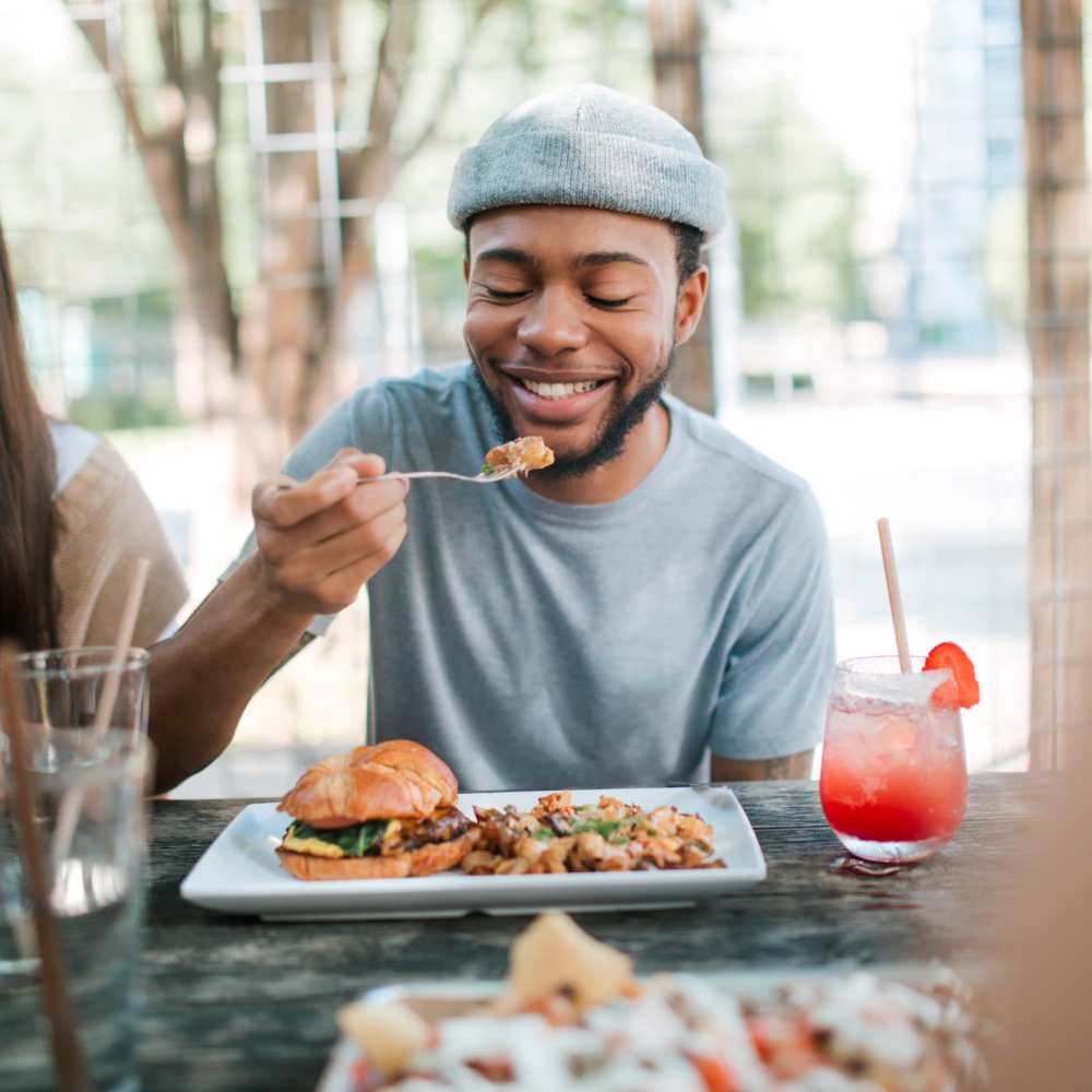 Man having his meal near The Edge in Pensacola, Florida