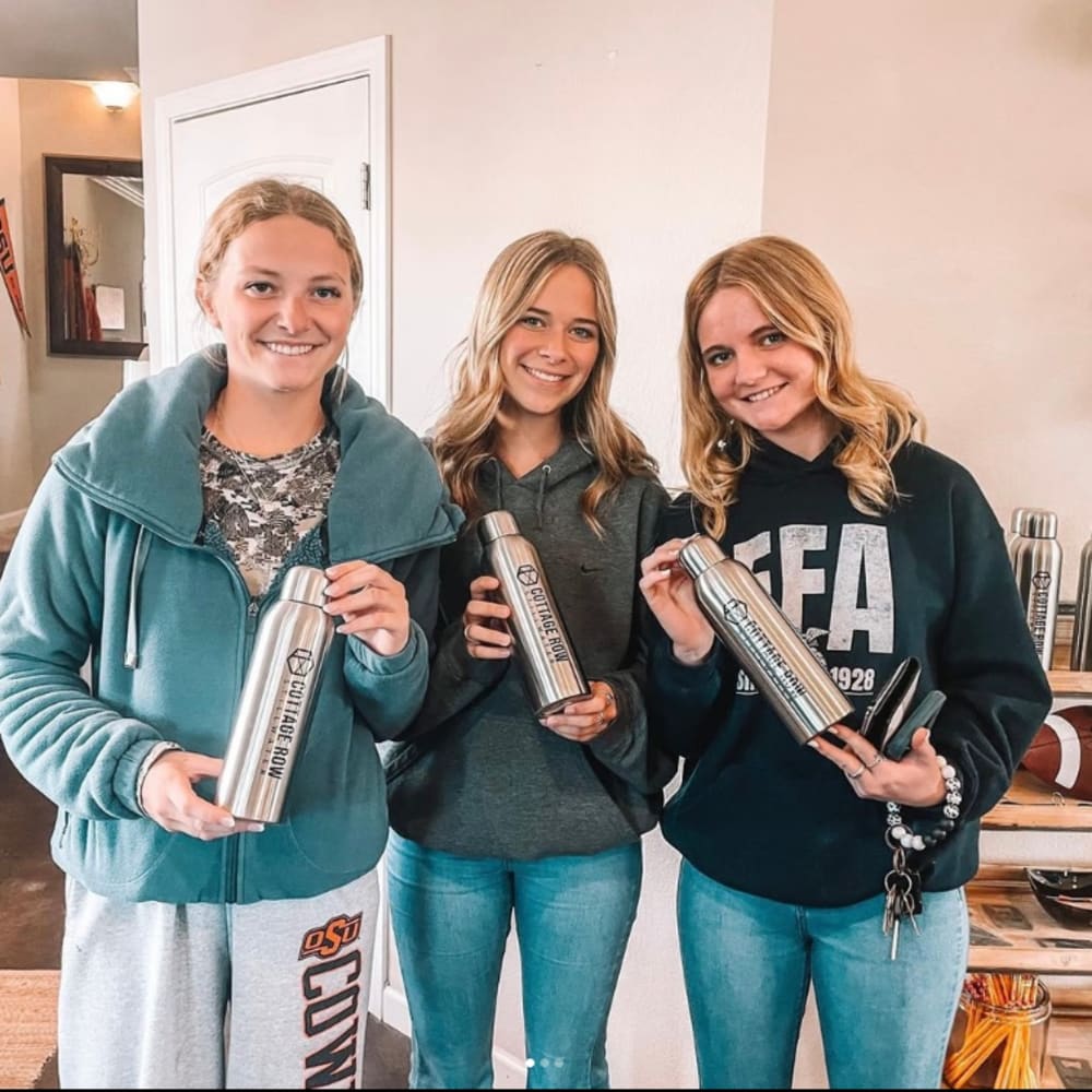 Students holding water bottle at Cottage Row Stillwater in Stillwater, Oklahoma 
