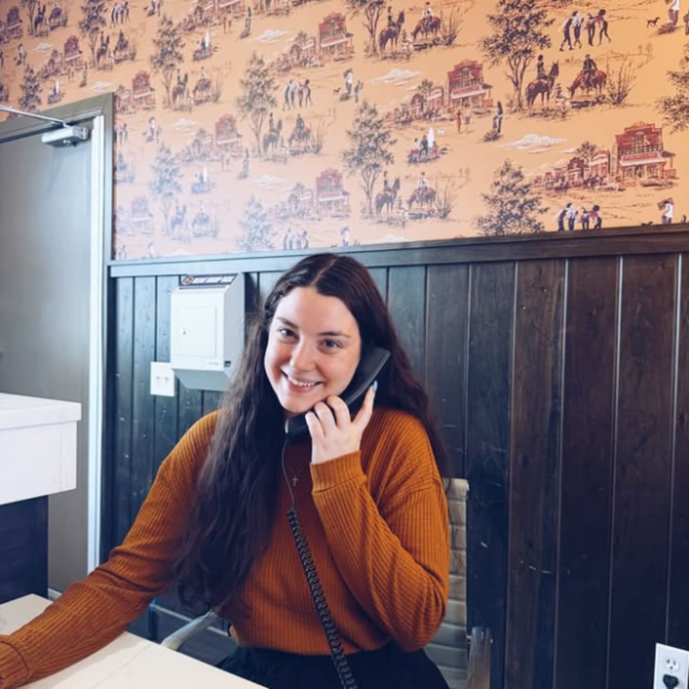 Student talking in landline phone  at Cottage Row Stillwater in Stillwater, Oklahoma