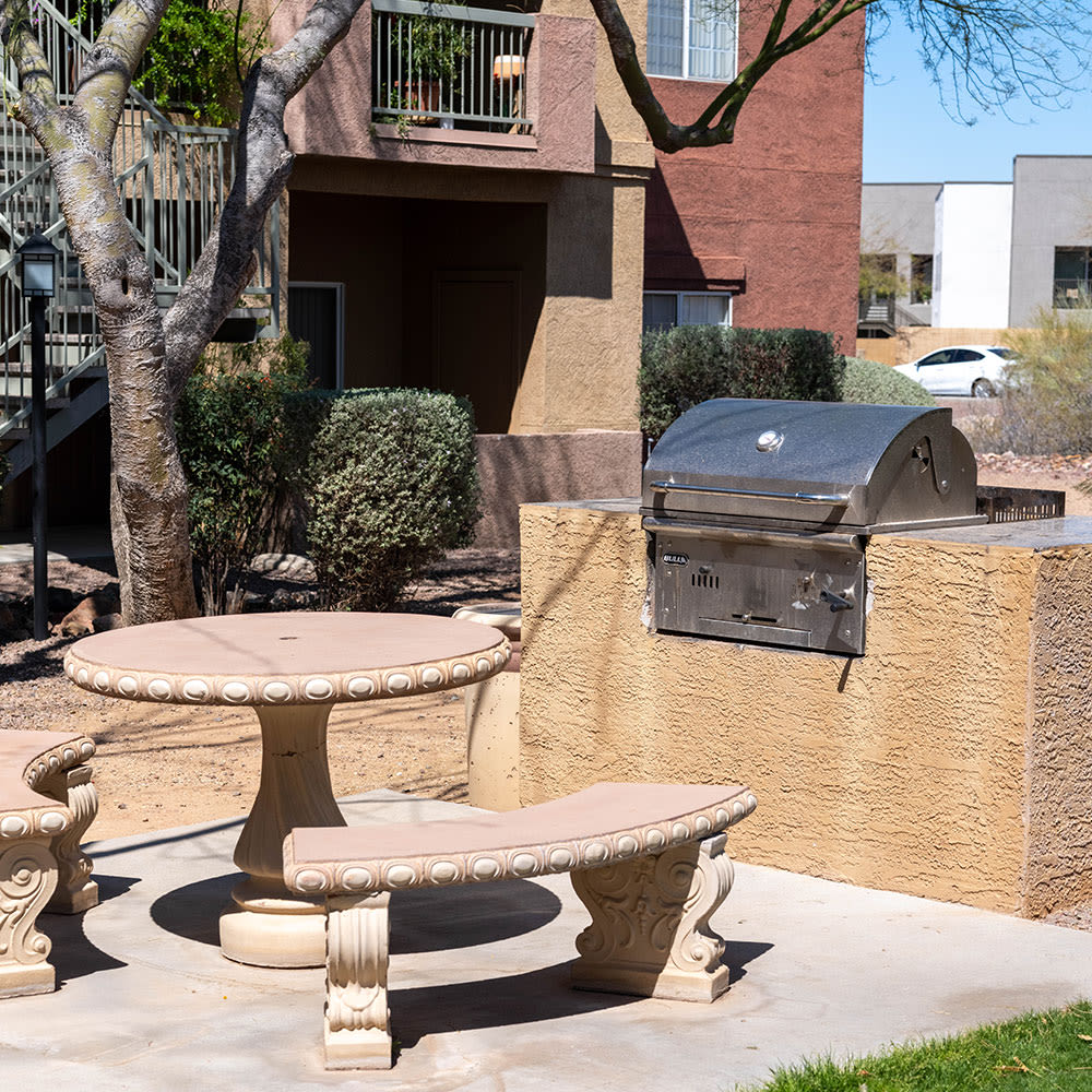 Resident and her dog playing outside on the green grass at Tierra Vida in Tucson, Arizona