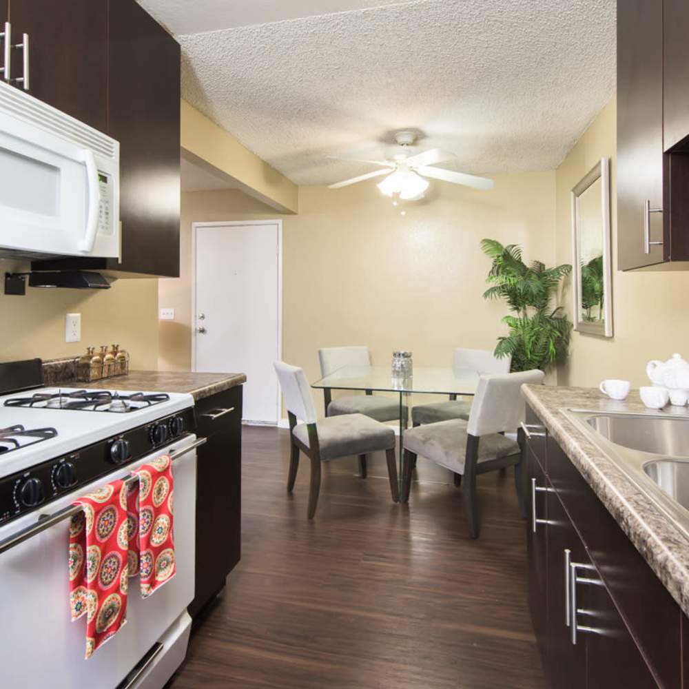 Kitchen with cabinets for storage at Village Green Apartments in San Jose, California