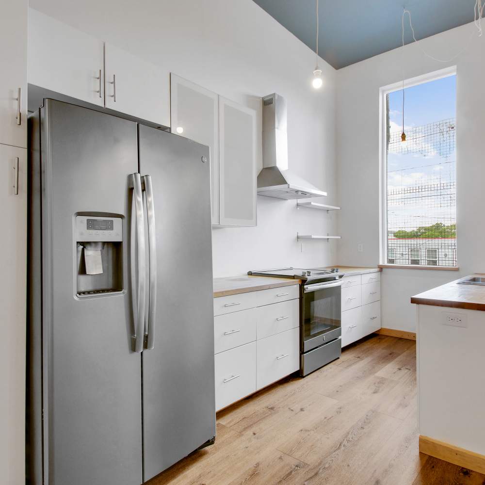 Kitchen with new appliances at The Lofts at 305 in Bryan, Texas