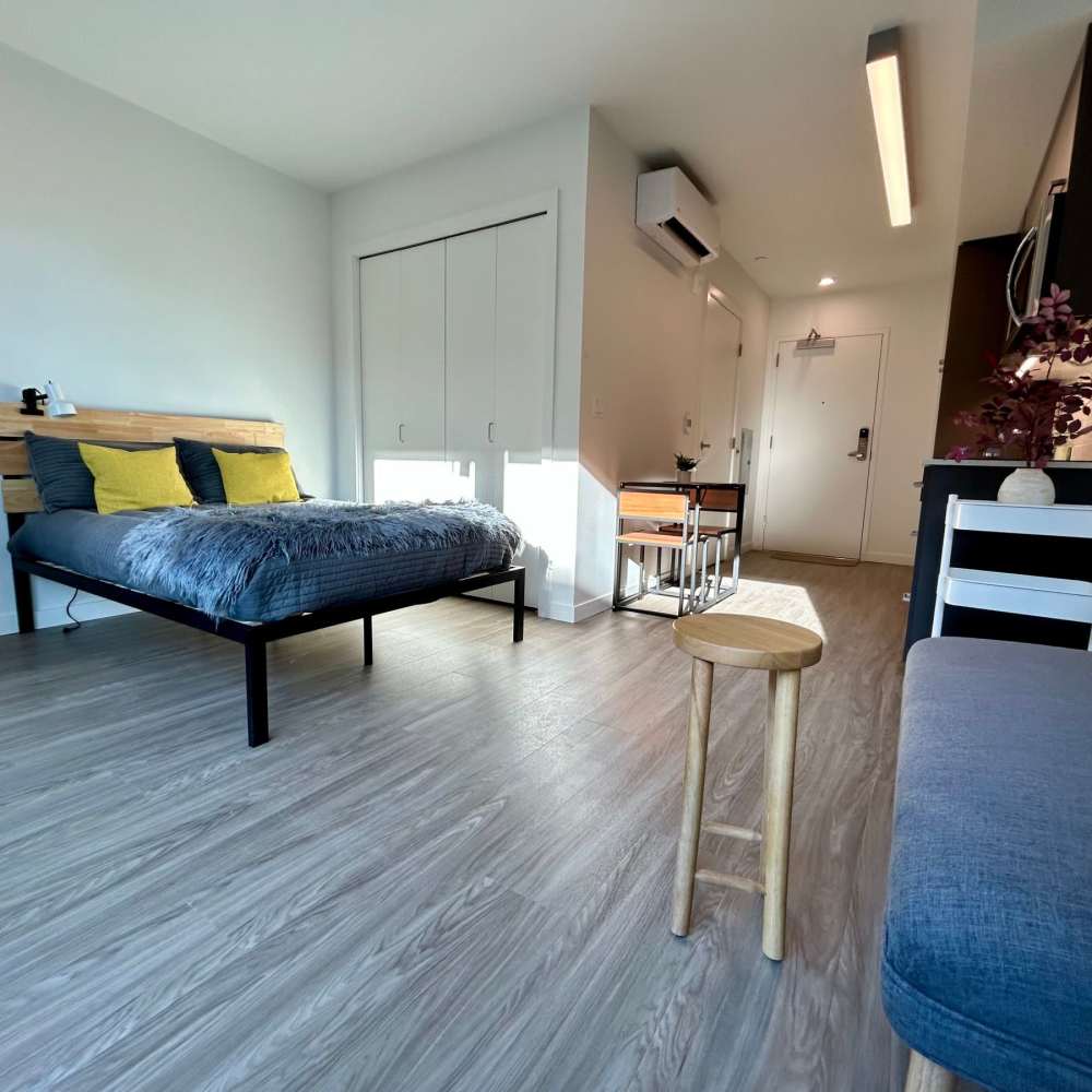 Studio apartment with wood-style flooring at DOCK 59 in Portland, Oregon