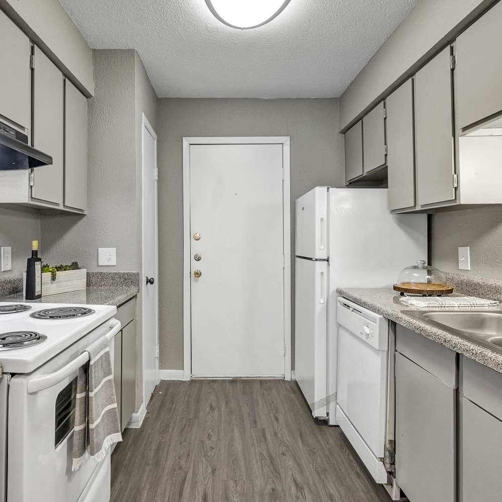Apartment kitchen with white appliances at The Ivy in College Station,Texas