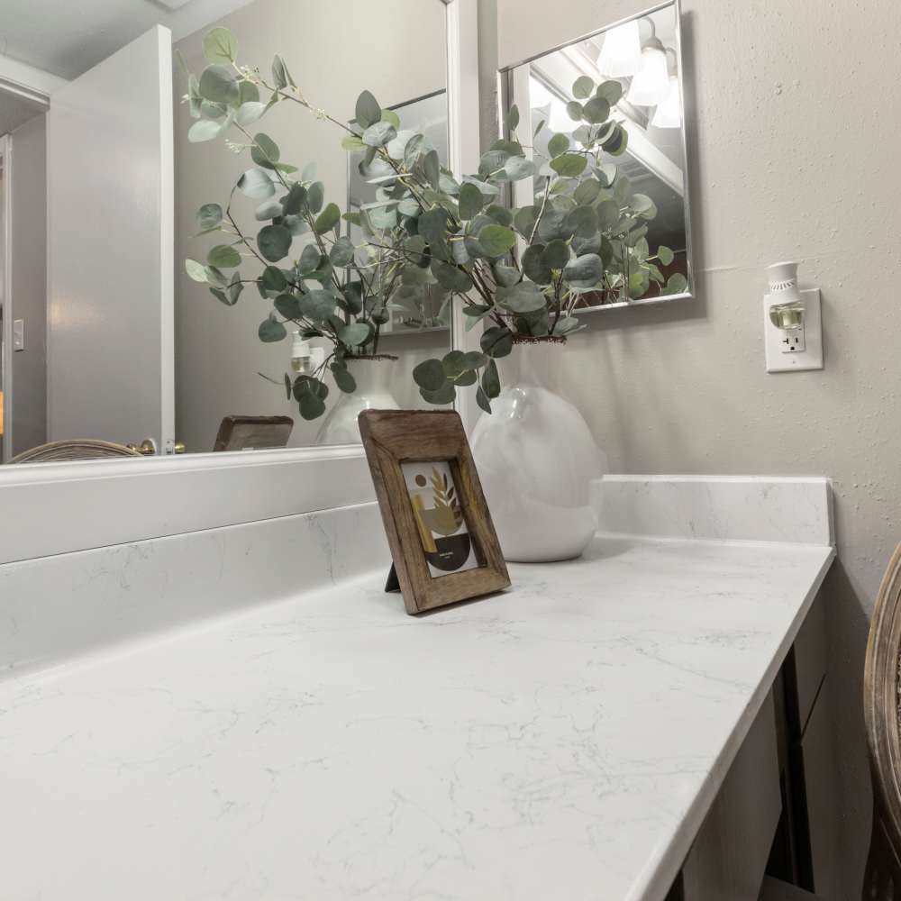 Bathroom with white granite countertop at The Ivy in College Station,Texas