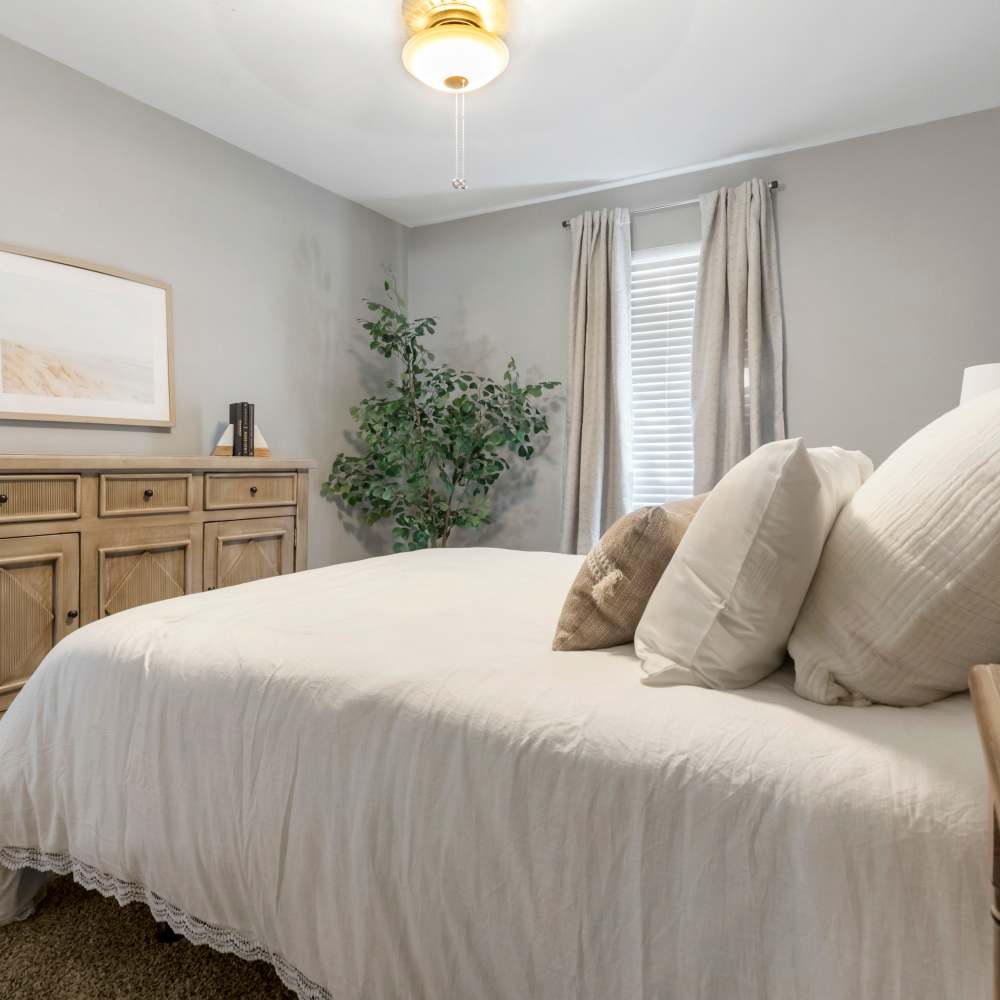 Bedroom with large bed and wooden storage units at The Ivy in College Station,Texas