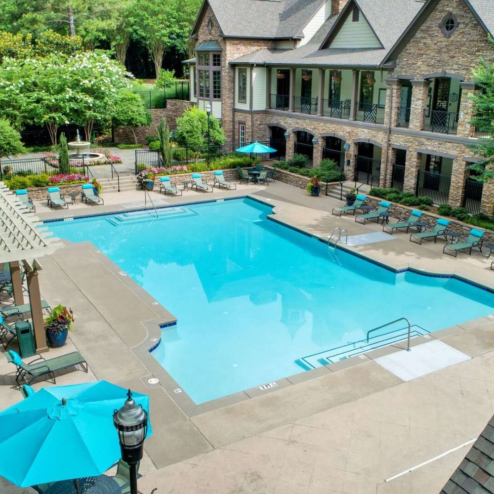 Beautiful aerial view swimming pool with chairs at Avonlea On The River in Duluth, Georgia
