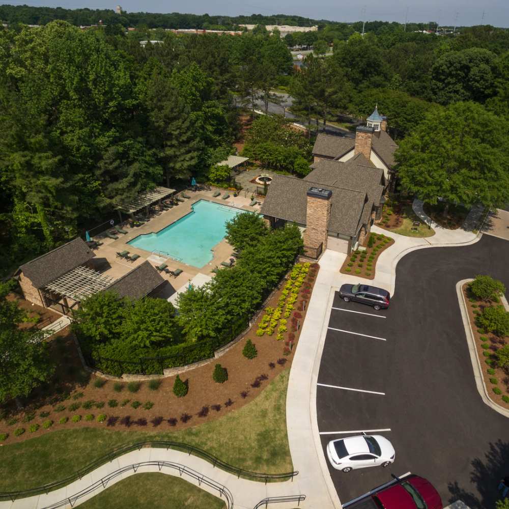 Aerial view of the resort-style swimming pool and clubhouse at Avonlea On The River in Duluth, Georgia