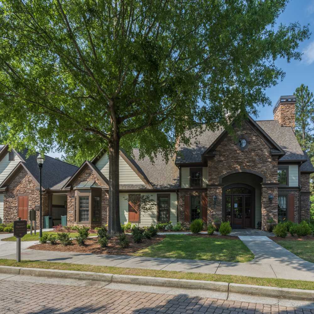 Beautiful exterior view of apartment with walking paths and green area at Avonlea On The River in Duluth, Georgia
