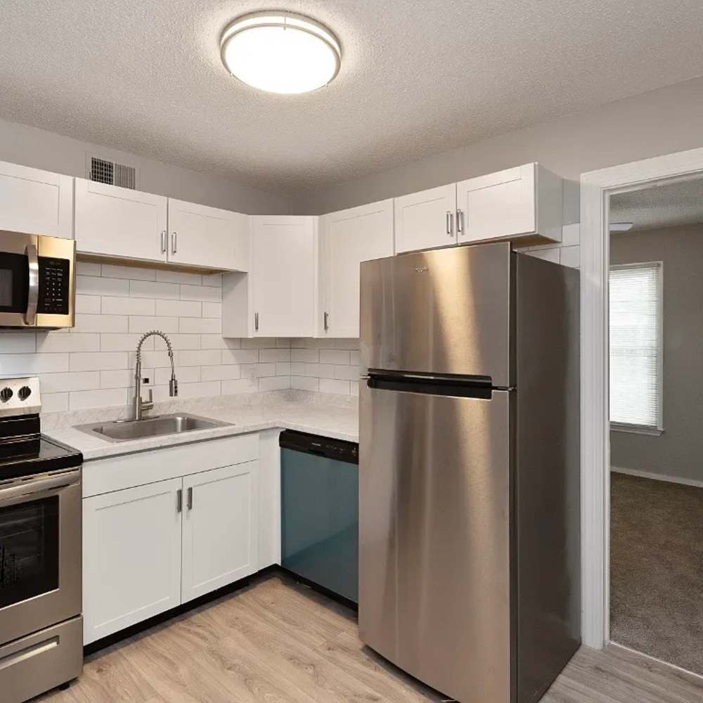 Modern kitchen with wooden cabinets, stainless-steel appliances, refrigerator and granite countertops at 1104 18th Ave S in Nashville, Tennessee