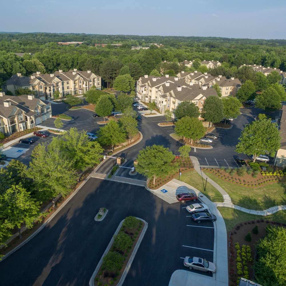 Aerial view community with parking lots at Avonlea On The River in Duluth, Georgia