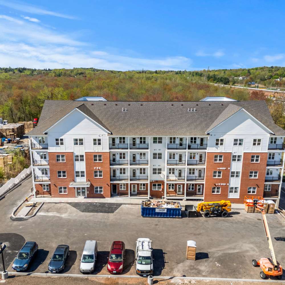 Exterior photo with parking for vehicles at Pomeroy Apartments in Meriden, Connecticut
