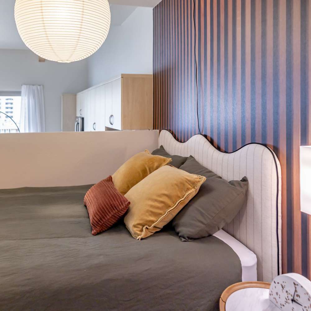Comfortable and cozy bedroom in a model home at Nova Apartment Homes in San Diego, California