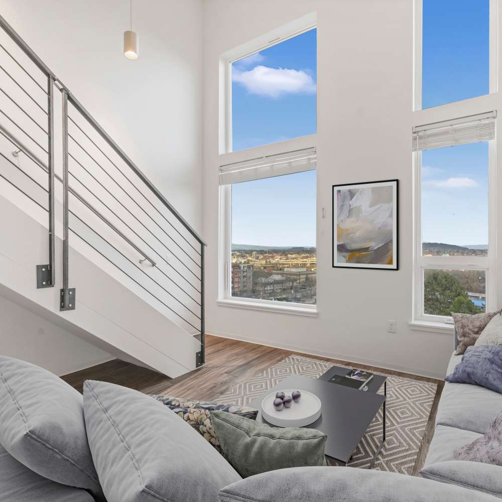 Modern living room with a high ceiling, large windows  at Koz on 4th in Portland, Oregon