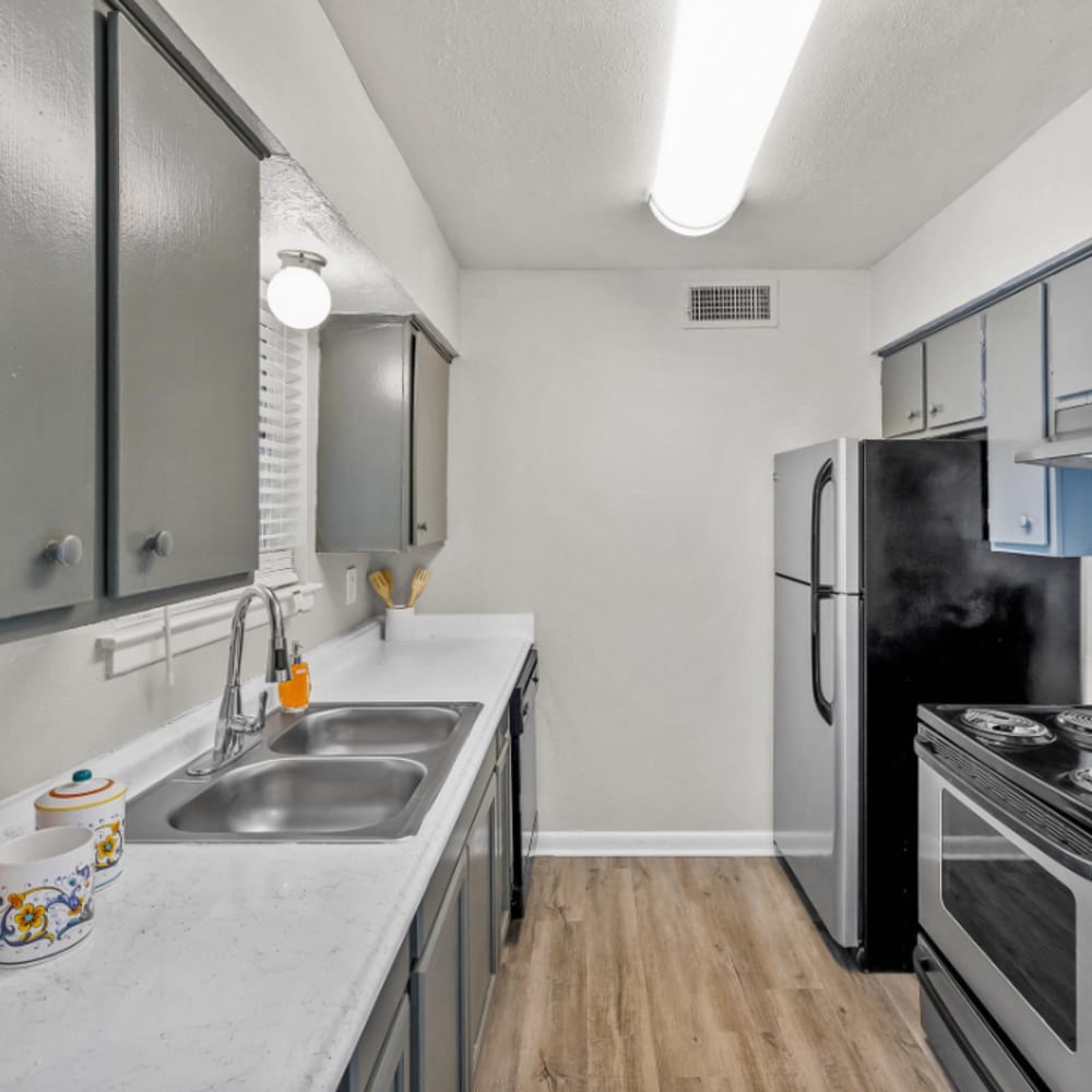 Apartment kitchen with wood-style flooring at The Hayes Apartments in Fort Worth,Texas