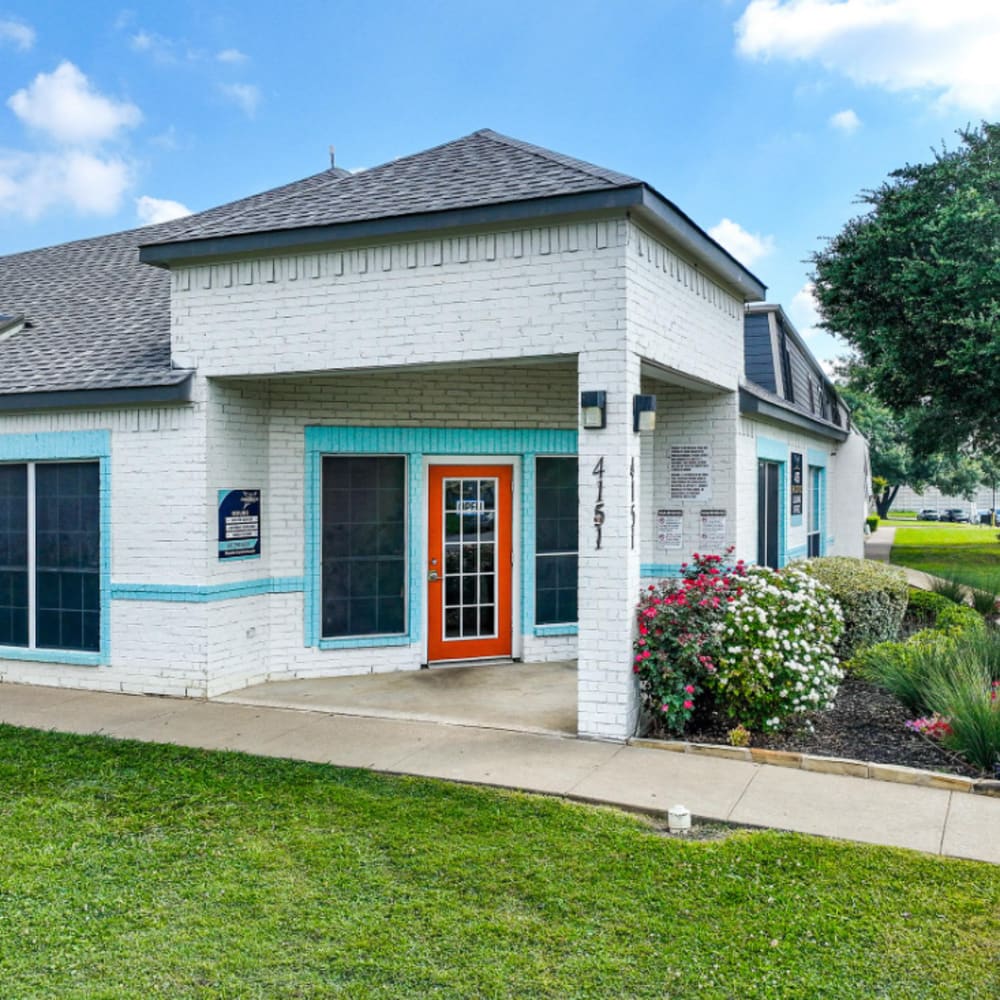 Property exterior with a lawn in the front at The Hayes Apartments in Fort Worth,Texas