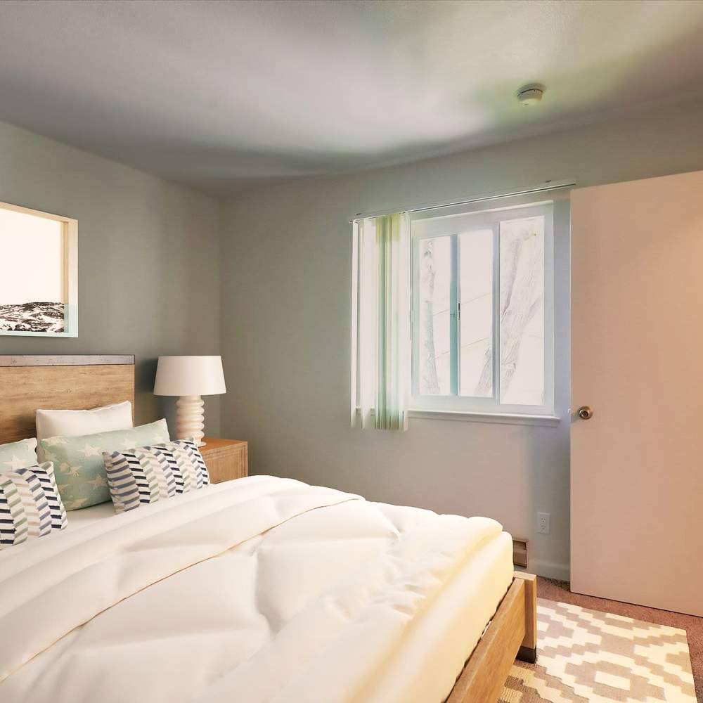Well-lit bedroom with a comfortable bed and a large window at Terman Apartments in Palo Alto, California