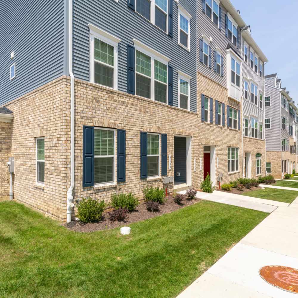 The outside of an apartment complex with greenery, located at Dorsey Overlook in Ellicott City, Maryland.