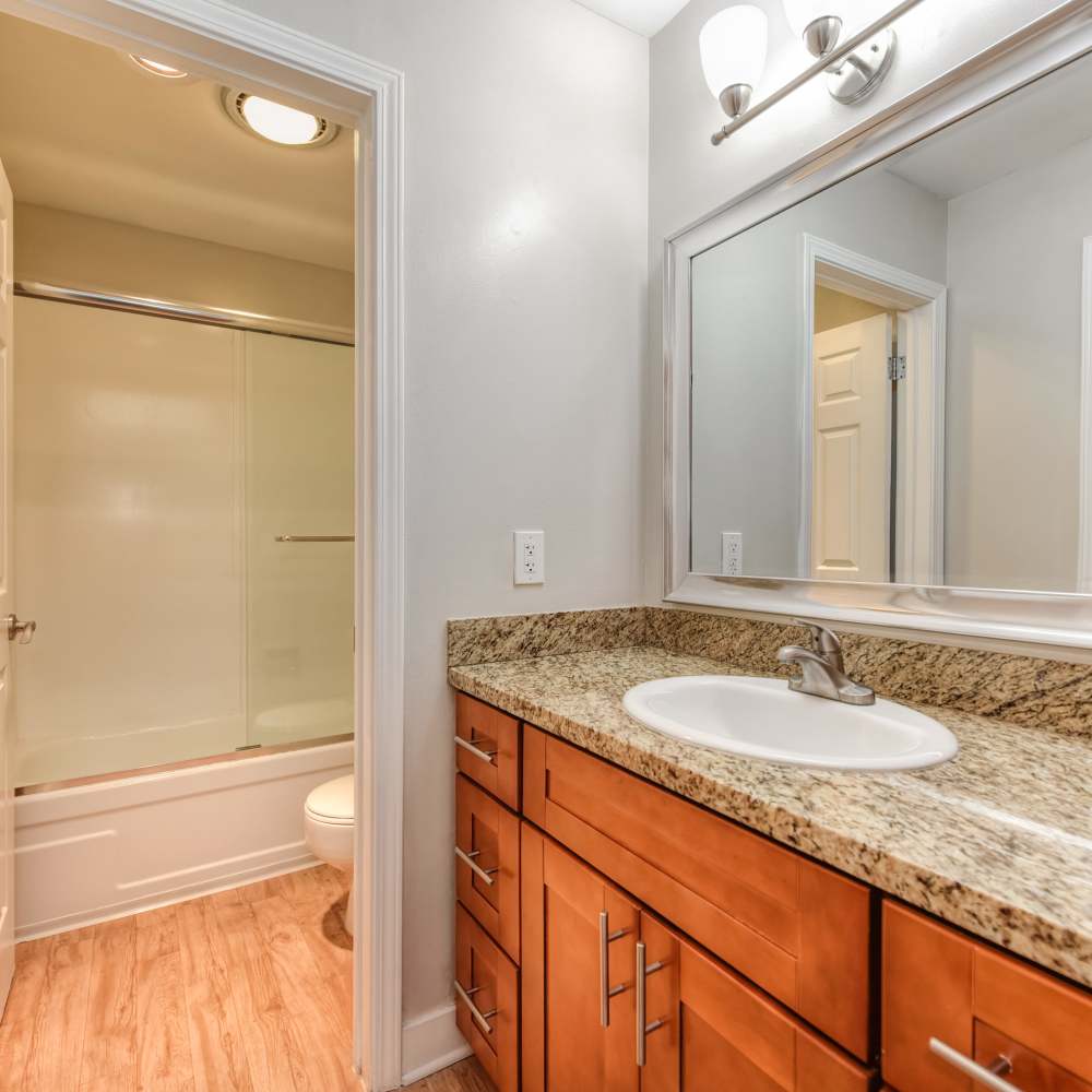 Bathroom with large mirror and pendant lights at Fayette Arms Apartments in Mountain View, California,