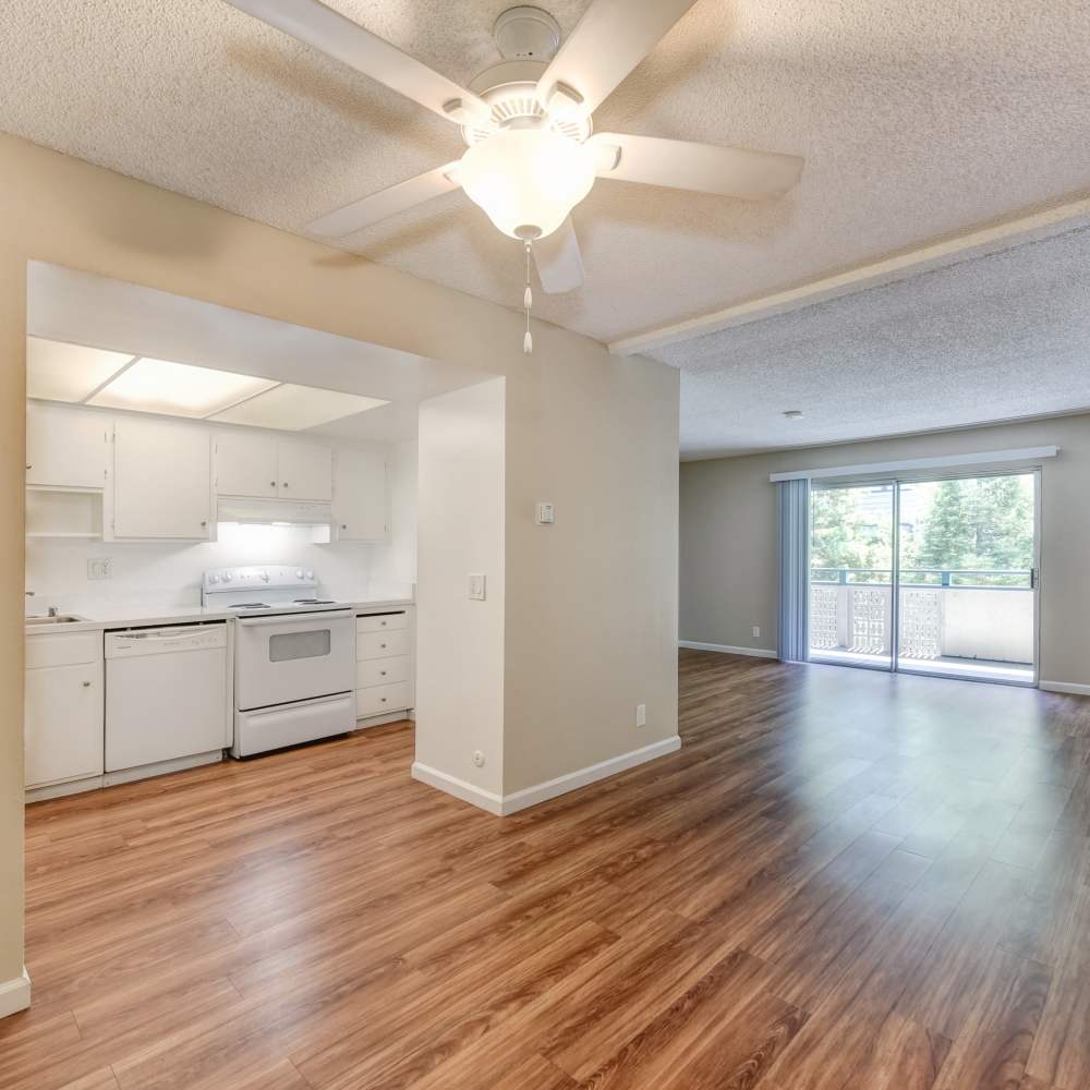 Living room connected to fully equipped kitchen at Fayette Arms Apartments in Mountain View, California,