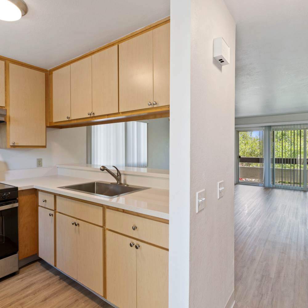 Kitchen looking into living room and entry to balcony Mission Gardens in Santa Cruz, California