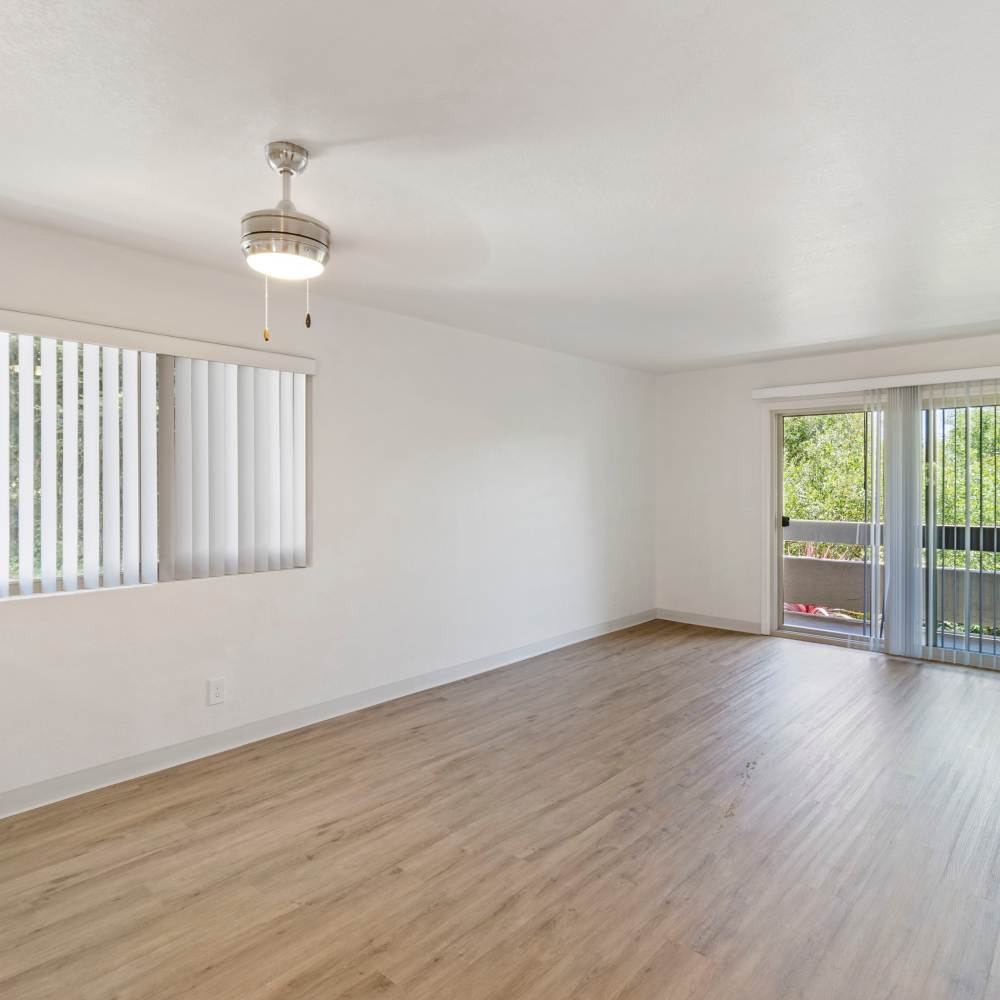 Living room with sliding glass entry to balcony at Mission Gardens in Santa Cruz, California