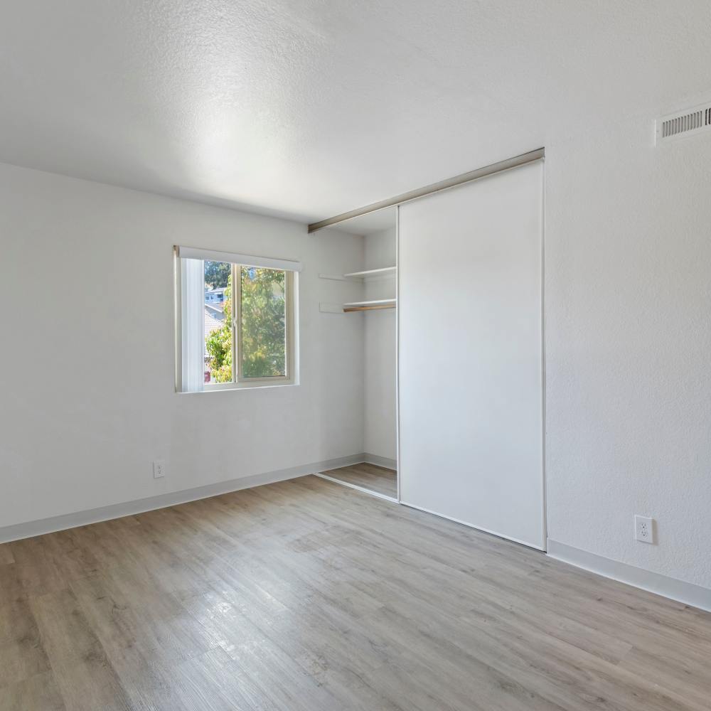 Bedroom with large closet and window at Mission Gardens in Santa Cruz, California