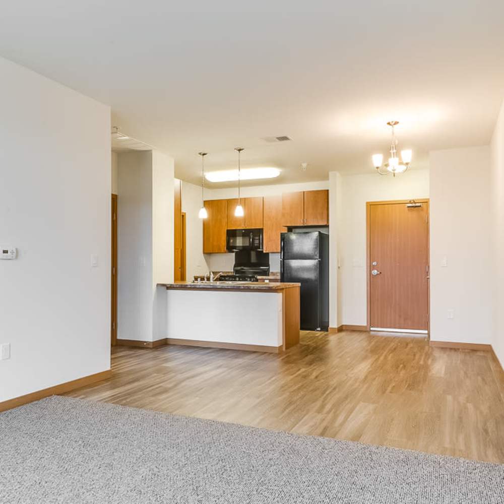 Spacious living room with a view of the kitchen at Layton Square in Cudahy, Wisconsin