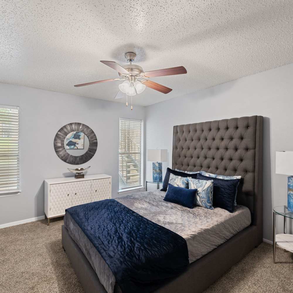 Cozy bedroom with bedside tables, small drawer and ceiling fan at The Madeleine in Fort Worth, Texas