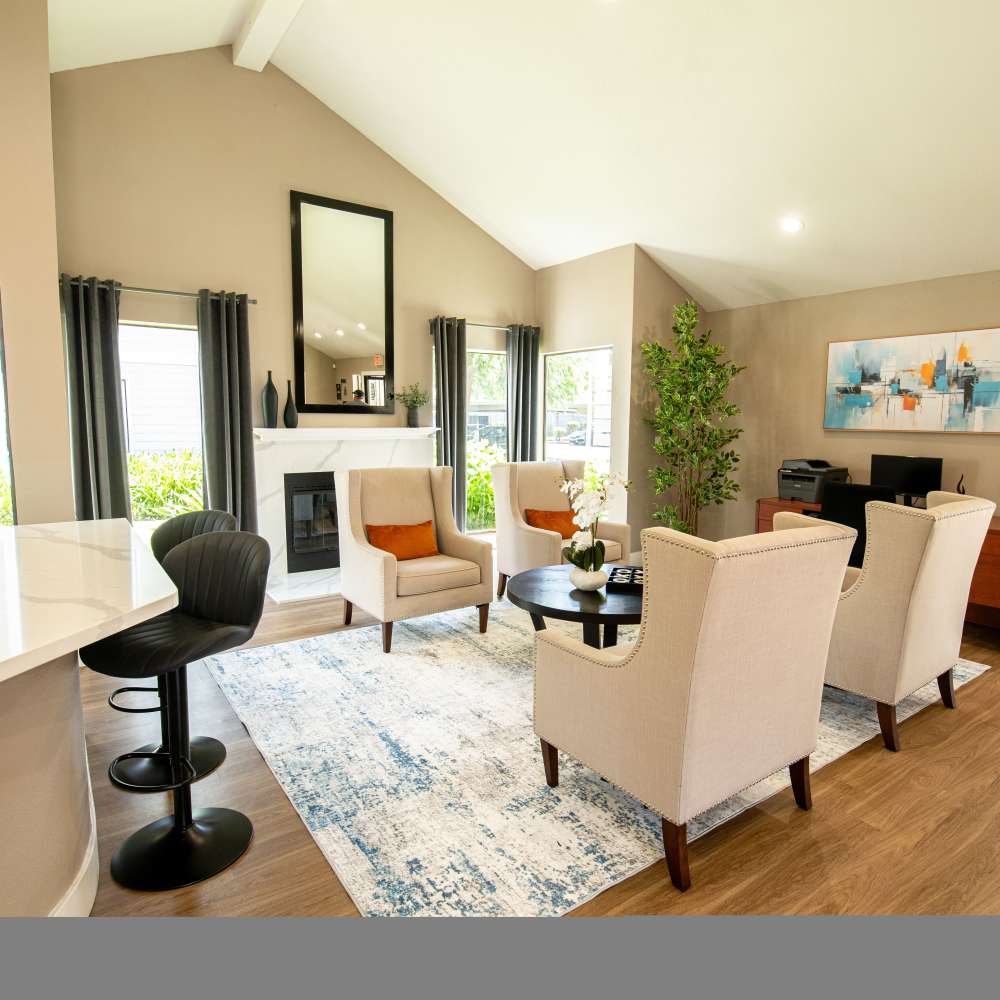 Stylish living area with seating, a fireplace, and a bar counter at Riverstone Apartment Homes, featuring modern decor at Riverstone Apartments in Sacramento, California