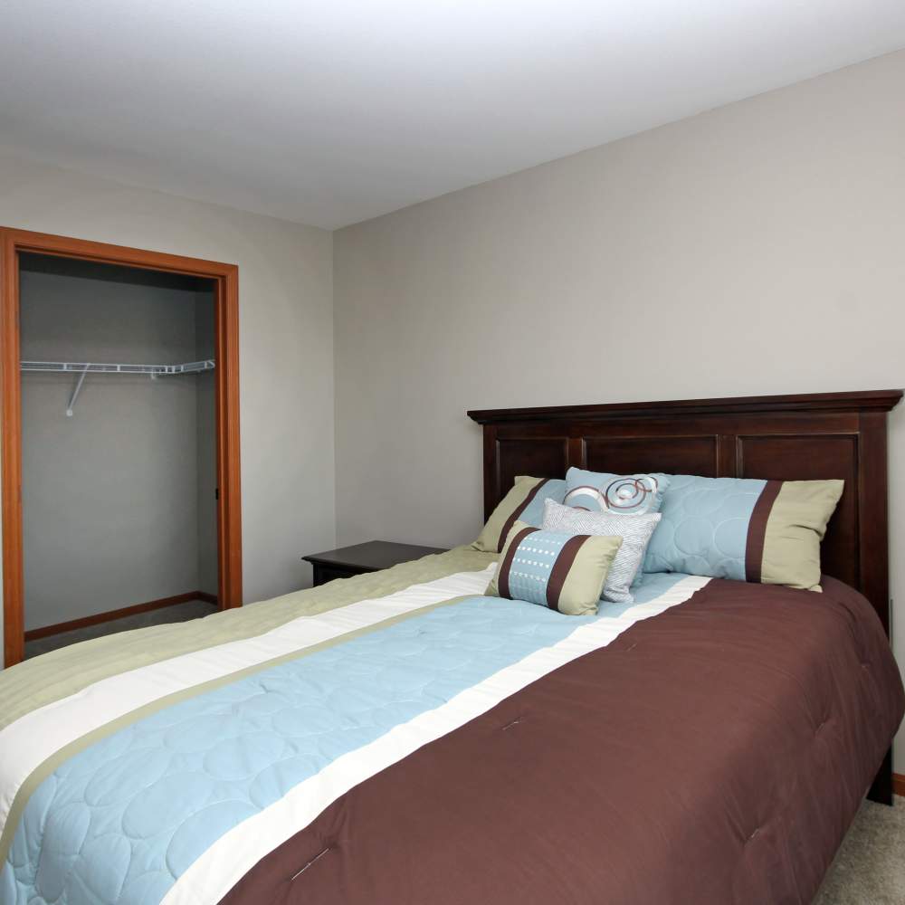 Bedroom with cozy bed at Parkview East in Ramsey, Minnesota