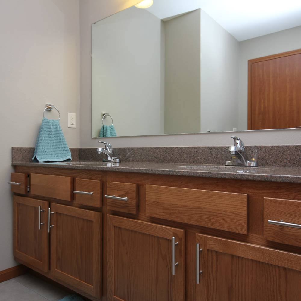 Bathroom with large vanity mirror at Parkview East in Ramsey, Minnesota