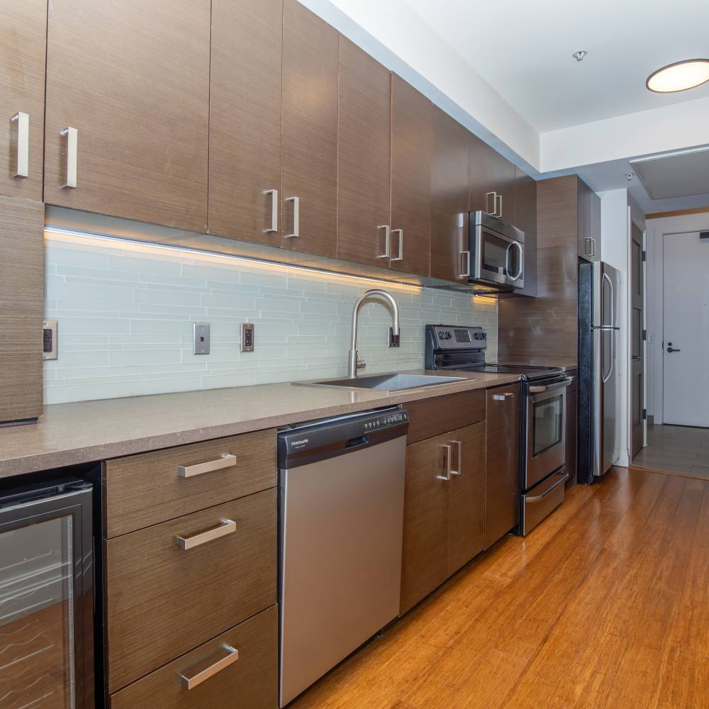 Kitchen with wooden cabinets at The View at Wash Park in Denver, Colorado