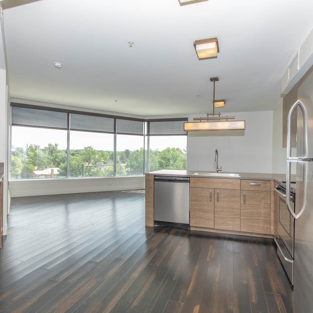 Well-lit living room with wood-style flooring at The View at Wash Park in Denver, Colorado