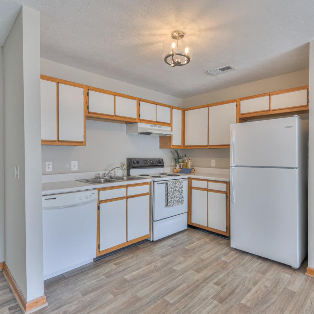 Kitchen with white appliances including refrigerator at Laurel Woods Apartments in Smyrna,Tennessee
