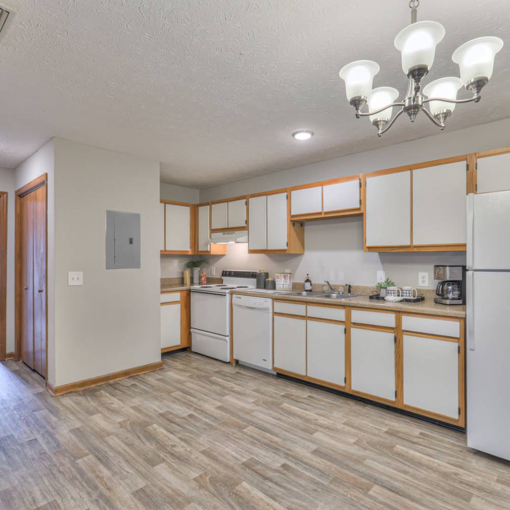 Apartment kitchen with wood-style flooring at Laurel Woods Apartments in Smyrna,Tennessee