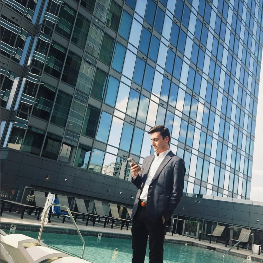 Man standing by the pool at The Eastern in Raleigh, North Carolina