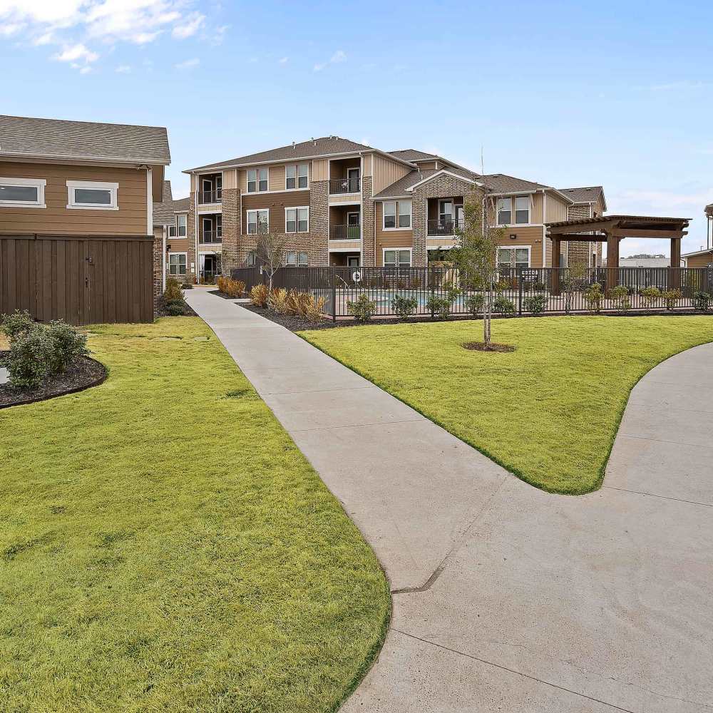 Exterior view of the apartment with walkway at Cedar Springs in Corsicana, Texas